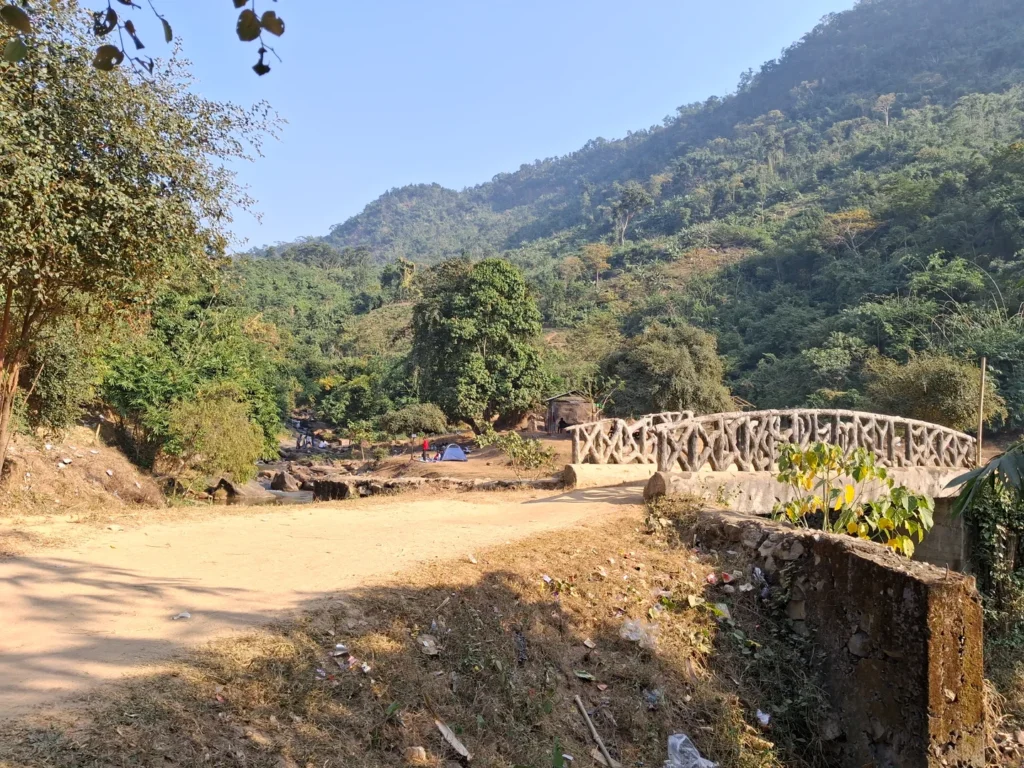 Wide angle view of the main spot with the iconic bridge on Kopili river Wide-angle view of Kopili Picnic Spot featuring the iconic bridge and lush greenery