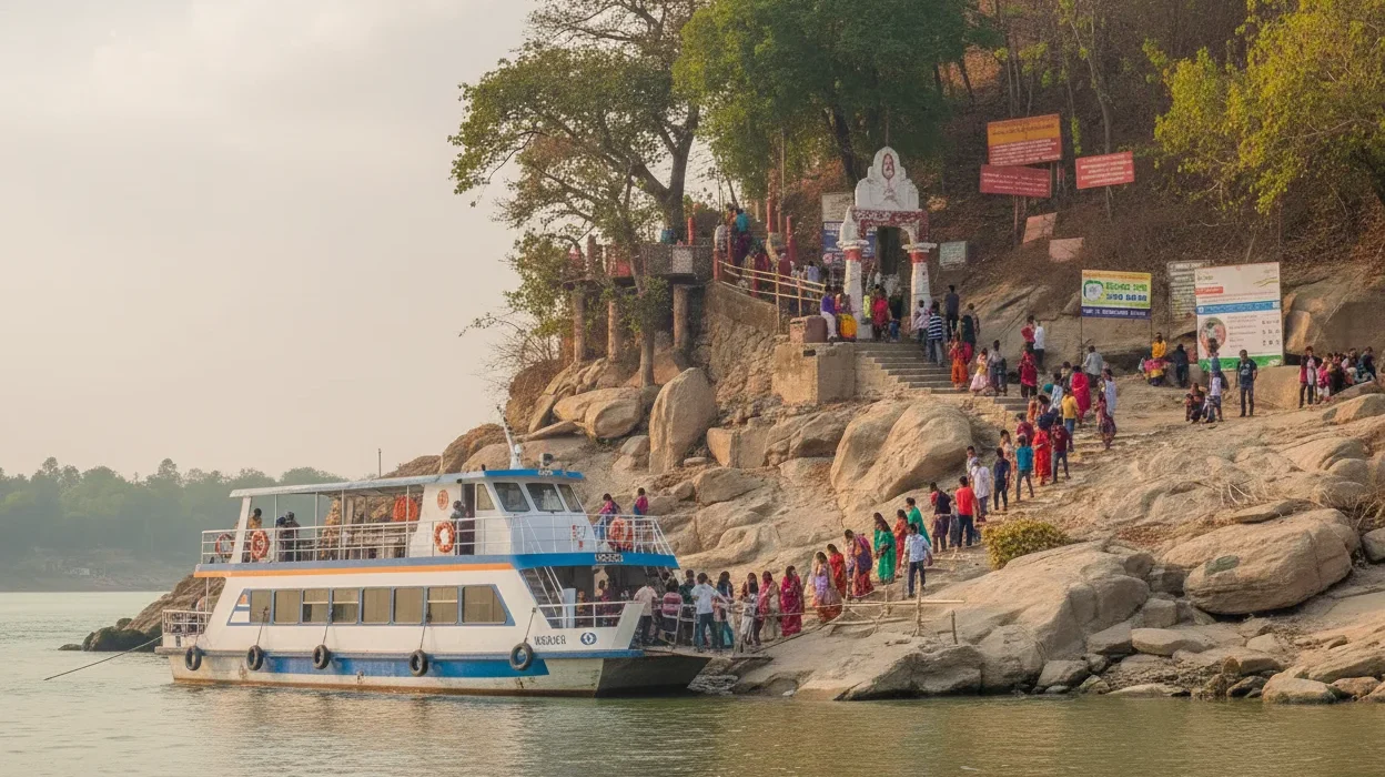 Ferry arriving at Umananda Island with visitors disembarking and walking up the steps toward Umananda Temple.