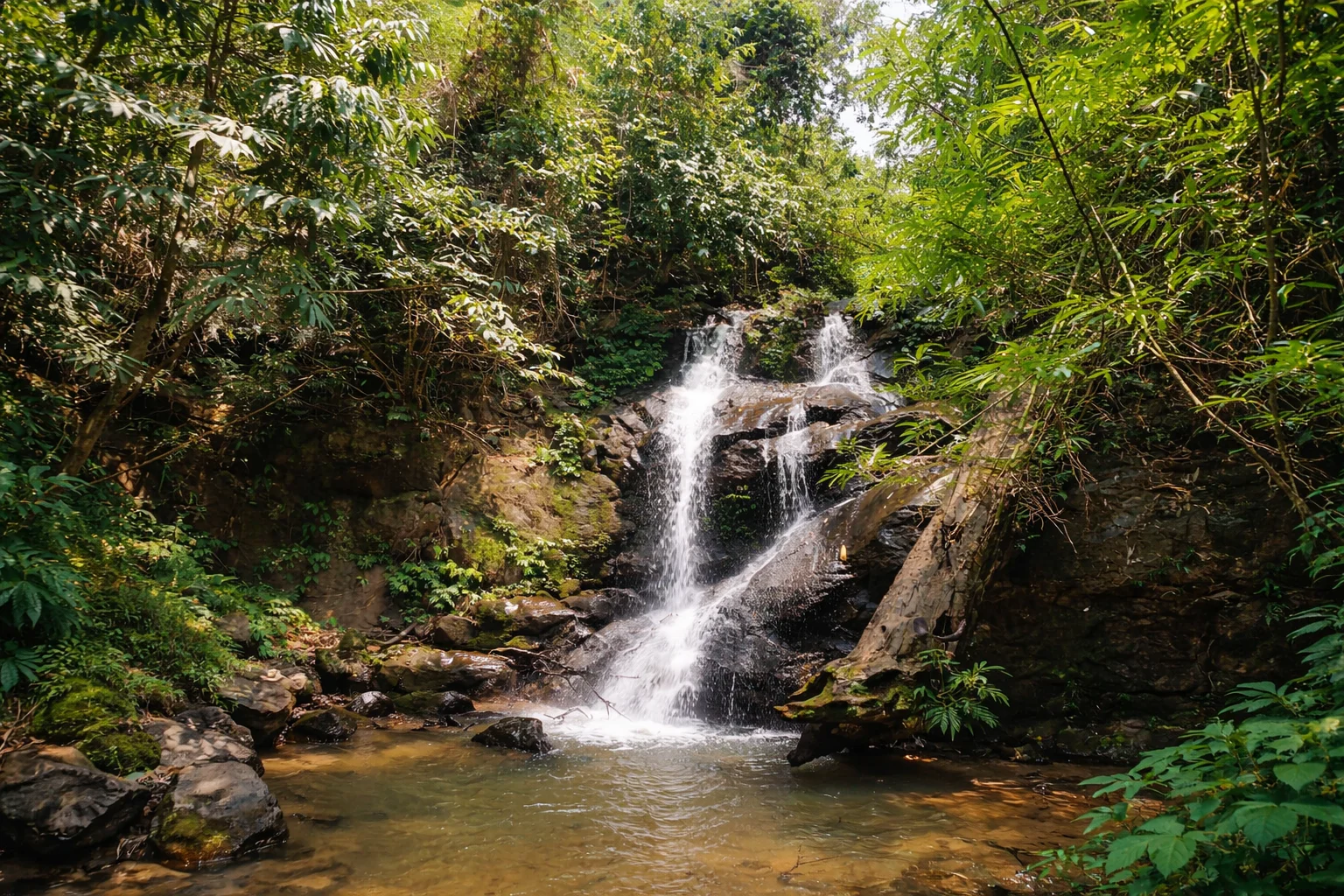 Theopani Waterfall surrounded by forest greenery, is one of the most scenic places to visit near Guwahati,