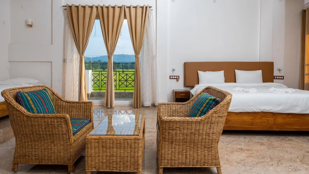 Luxury room with balcony and mountain view at The Kaziranga Address